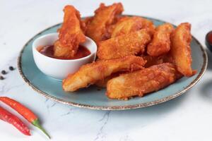 Potatos wedges with tomato sauce served in dish isolated on background side view of fastfood photo