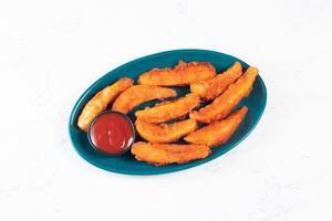 Potatos wedges with tomato sauce served in dish isolated on background side view of fastfood photo