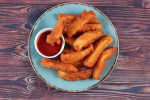 Potatos wedges with tomato sauce served in dish isolated on background side view of fastfood photo