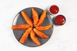 Potatos wedges with tomato sauce served in dish isolated on background side view of fastfood photo