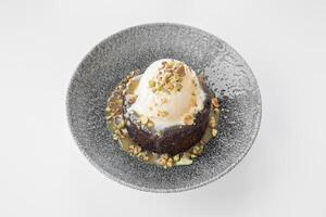 Sticky Toffee Pudding served in a dish isolated on grey background side view photo