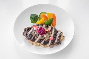 Tenderloin Steak with salad served in a dish isolated on grey background side view photo