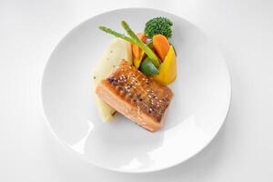 Grilled Salmon with salad served in a dish isolated on grey background top view photo