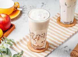 Pearl milk tea Boba Bubble tea in glass jar on mat with grey background breakfast drink photo