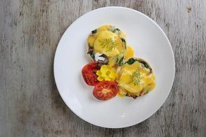 Eggs Benedict Bacon Rashers served in dish isolated on wooden background top view of breakfast photo