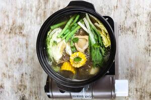 Bone Marrow Bulalo Soup with corn and vegetable served in a bowl isolated on grey background side view of stewed photo