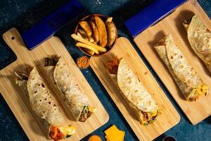 Beef Seekh Kabab shawarma, Chicken Afghani Kabab Wraps, Melt Cheese Paneer Wrap, Egg Cheesy Chicken Burger Wrap, Melt Cheese Chicken Wrap, Wedges and fries with salad dip and sauce isolated fastfood photo