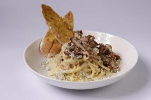 GRILLED CHICKEN Spagetti CARBONARA in a dish top view on grey background singapore food photo