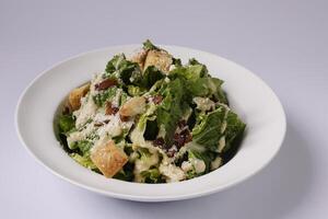 healthy CLASSIC CAESAR SALADin a dish top view on grey background singapore food photo