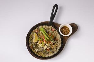 VEGETARIAN JAMBALAYA vegan rice in a dish top view on grey background singapore food photo