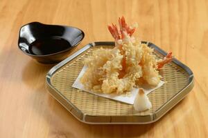 japanese food Deep Fried ebi tempura shrimp in a tray with chili sauce on wooden background top view photo