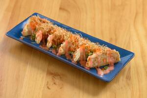 Japanese food Mentaiko Gyoza fried dumplings in a bowl isolated on wooden table top view photo