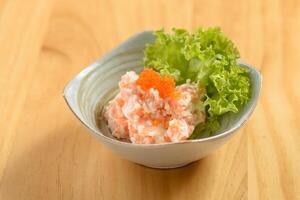 japanese food Shishamo Mentai sauce in a bowl isolated on wooden background top view photo