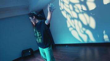 Contemporary dancer practicing with shadow play in a dimly lit studio video