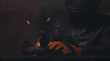 Dramatic shot of a man welding in an old garage, working with steel, close-up of a work place, welding as a hobby video