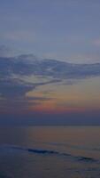 Vertical time lapse video of dramatic dawn to sunrise at a tropical beach.