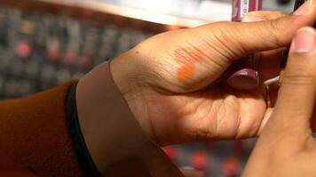 A gesture of applying carmine lipstick to the flesh of another persons hand video