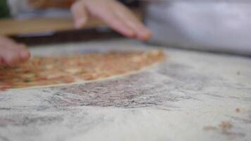 the chef's hands form a round pizza base from the dough with his hands. video