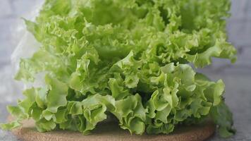 green lettuce leaves on a chopping board on table video