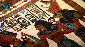 Egyptian papyrus with pharaohs and hieroglyphics representation of turning video