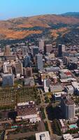 Square districts of sunny Salt Lake City at daytime. Lovely view of beautiful American city from aerial perspective. Vertical video