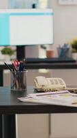 Vertical video Stock market diagrams with charts and stock figures on laptop sitting on desk in empty workplace. Forex investment listings displayed on notebook screen in financial department, panning shot