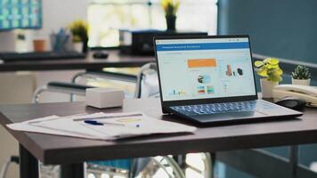 Business figures on laptop monitors left open in company workspace, panning shot. Notebook with economic charts in empty accounting department office used for financial analysis purposes video