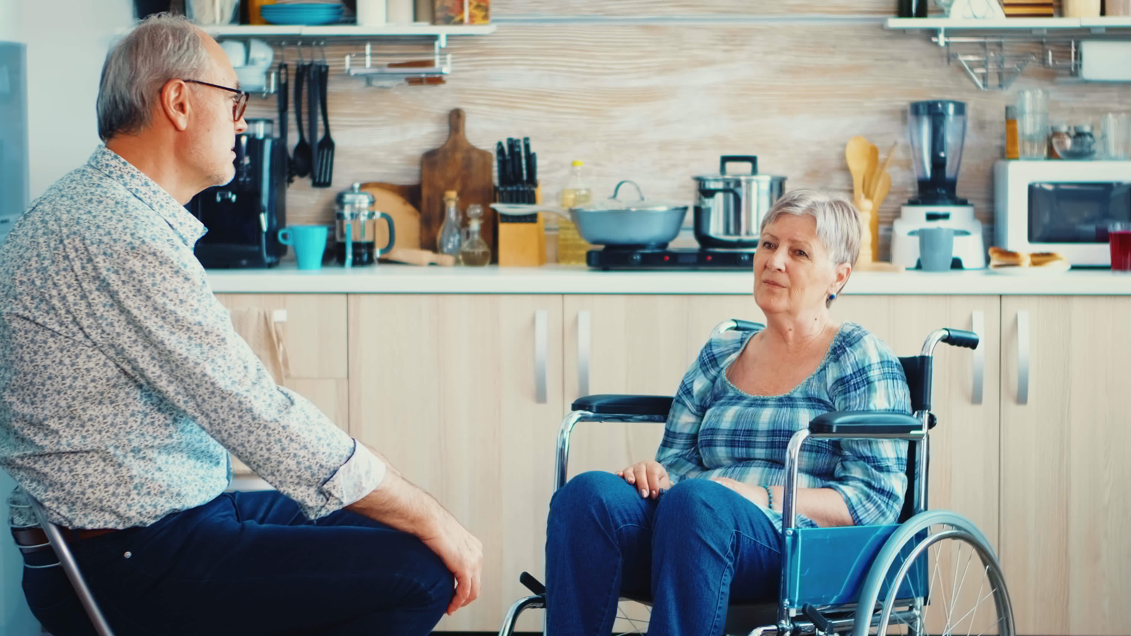 Retired invalid woman in wheelchair having a conversation with old Retired invalid woman in wheelchair having a conversation with old