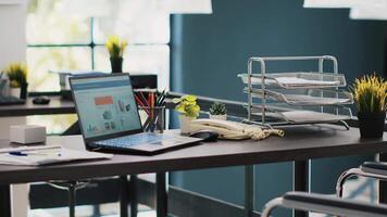 Documents on laptop screen in office containing business financial information income statements. Company invoice files displayed on notebook monitor in accounting workspace video