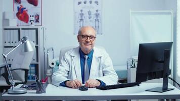 Authentic portrait of doctor smiling to the camera in modern private clinic. Healthcare system specialist practitioner. Handheld slow motion shot. video