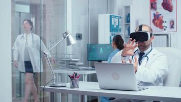 Medical personnel working with virtual reality. Healthcare system workers walking in hallway and patients in busy modern private clinic. Medical technology of future video