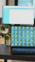 vertikal video skrivbord i tömma kontor med bärbar dator som visar stock utbyta data samlade in till utveckla handel strategier. forex analys på anteckningsbok skärm i företag arbetsplats som visar handel plattform