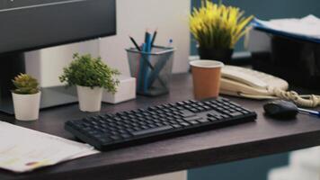 Business graphs and figures on laptop showing upward profit trend on desk next to wheelchair. Economic annual report charts on notebook in inclusive company office for workers with disability video