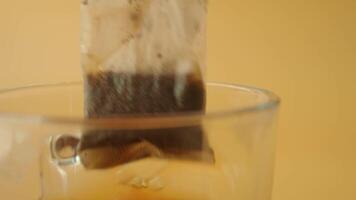 Cup of tea with tea bag on wooden table close-up. video