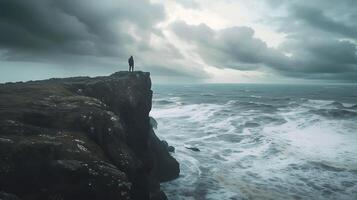 AI generated Resilience and Hope Figure Stands on Windswept Cliff Facing Turbulent Ocean Embraced by Clearing Storm and Sunlit Sky photo