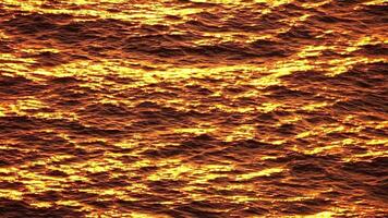 Sea water surface. Aerial view on golden sea water at sunset. Sun glare. Abstract nautical summer ocean nature. Holiday, vacation and travel concept. Nobody. Slow motion. Weather and climate change video