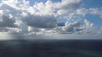 Aerial view. Dramatic sunset with sea and gloomy clouds. Abstract aerial nature summer ocean sunset sea and sky background. Horizon. Vacation, travel and holiday concept. Weather and climate change video