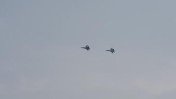 Military aircraft, combat fighters in the sky overhead. Parade of military equipment, air show video