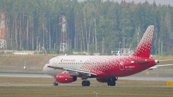 MOSCOW, RUSSIAN FEDERATION - JULY 29, 2021. Sukhoi Superjet 100, RA-89047 of Rossiya passenger plane taxiing, side view. Travel concept video