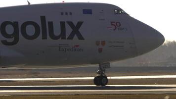 NOVOSIBIRSK, RUSSIAN FEDERATION - OCTOBER 20, 2021. Wide-body cargo airliner Boeing 747 of Cargolux taxiing at Tolmachevo airport, middle shot, side view video