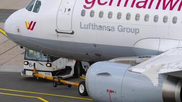 DUSSELDORF, GERMANY - JULY 23, 2017. Tractor towing a plane of the budget airline Germanwings at Dusseldorf airport. Tourism and travel concept video