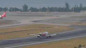 PHUKET, THAILAND - FEBRUARY 13, 2023. Jet airplane VietJet Air slow down after landing at Phuket airport. Spoilers up. Cinematic shot of flight arriving. Vietnamese low-cost airline video