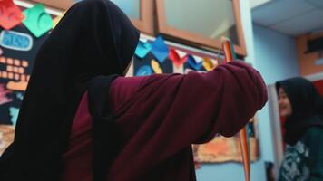 Teacher pointing to a board in a colorful classroom setting video