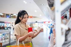 young woman in smart casual wear carrying many paper shopping bags walking and shopping in clothing and shoe at shopping center photo