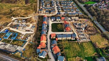 Aerial view of a suburban development with rows of houses, showing construction areas and completed homes with red roofs in Harrogate, North Yorkshire. photo