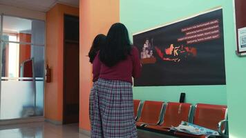 Teacher and student interacting with an interactive digital blackboard in a modern classroom setting. video