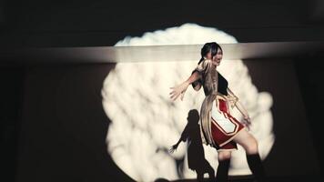 Elegant female dancer with a joyful pose in spotlight, dark background, artistic shadows. video