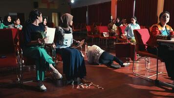 Person in hoodie lying on the floor, depicting urban lifestyle or youth culture, with blurred background. video