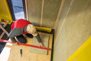 Contractor Cutting to Size Mineral Wool Insulation Material photo