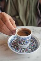 women drinking turkish coffee at cafe photo